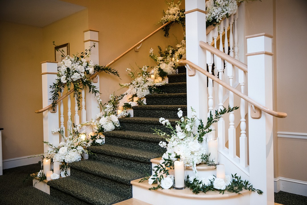 wedding staircase flowers, stairwell flowers, wedding staircase floral arrangements, white wedding staircase flowers