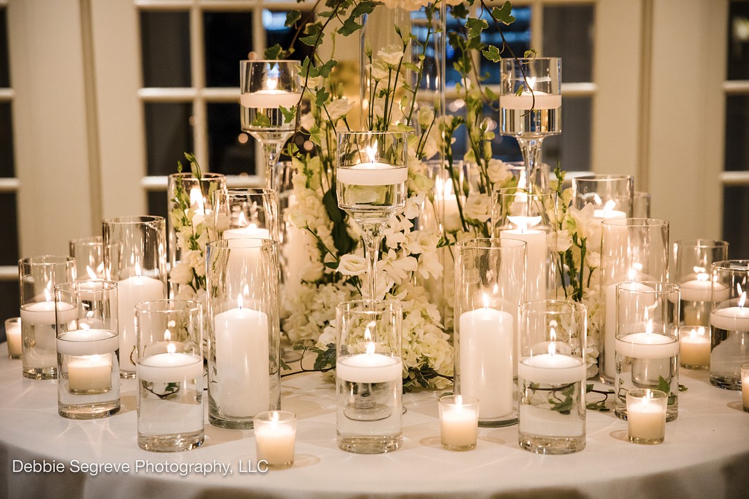white themed wedding centerpieces with gold accent and floating candles