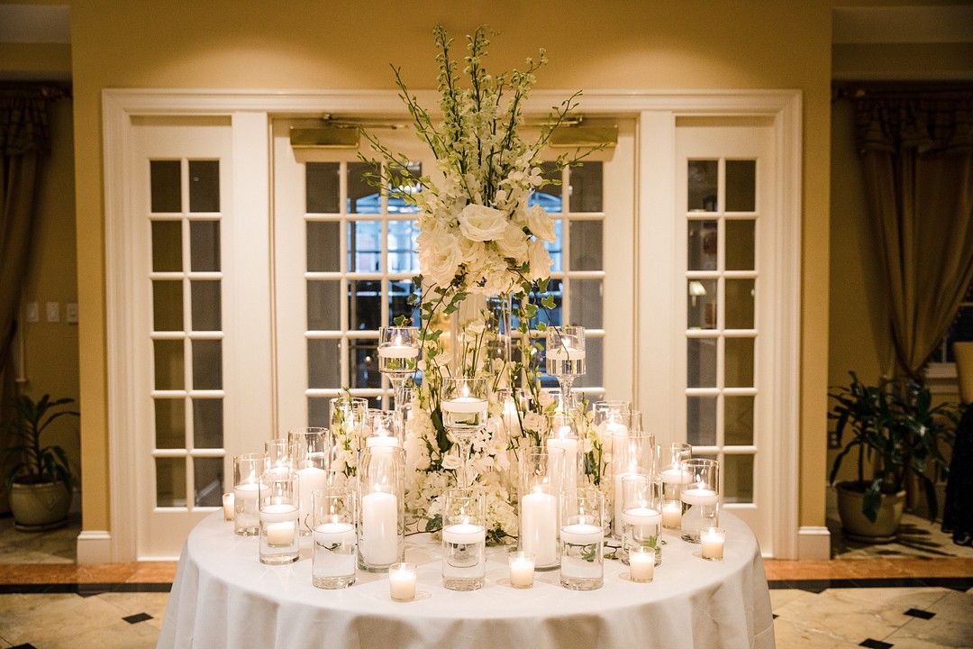beautiful white themed wedding centerpiece with white candles