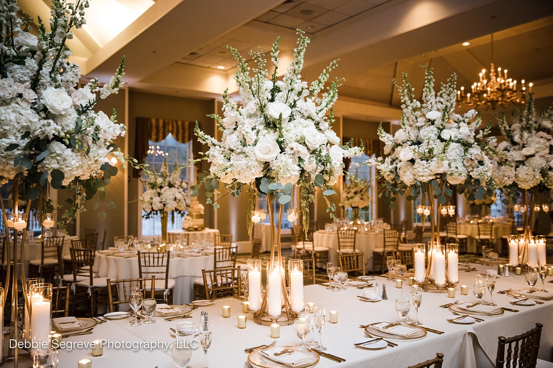 white roses and hydrangea with Silver Dollar & Seeded Eucalyptus wedding centerpices, tall gold stands with candles