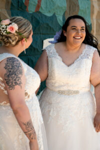 two brides laughing, happy after just marrying each other