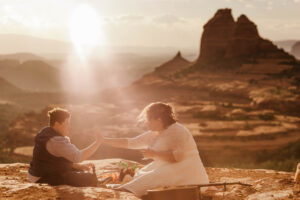 lgbt couple enjoying picnic at sedona wedding in arizona