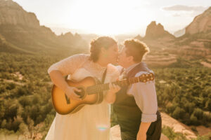 lgbt wedding couple first kiss with guitar